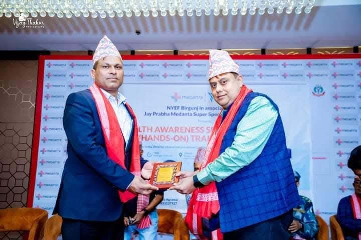 Dr. Niraj Kumar Singh exchanging a memento at a health awareness seminar and hands-on training event in Birgunj.